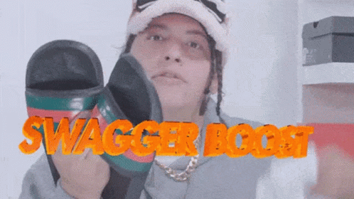 A Man Wearing A Hat And Holding A Pair Of Sandals With Swagger Boost Written On It GIF