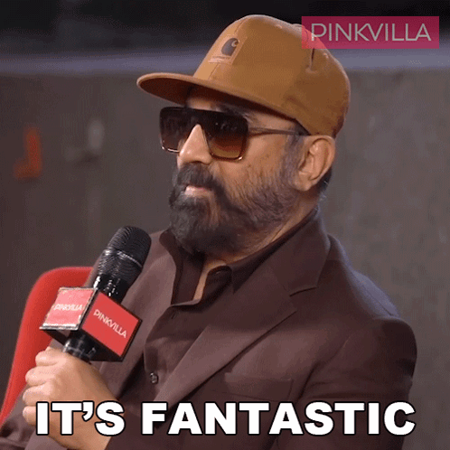 A Man Wearing A Hat And Sunglasses Holds A Microphone And Says " It 'S Fantastic " GIF
