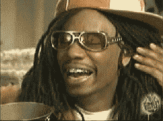 A Man Wearing A Hat And Sunglasses Is Smiling GIF