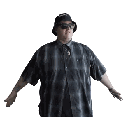 a man wearing a hat and sunglasses is standing with his arms wide open