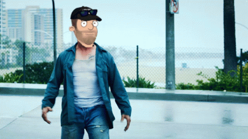 A Man Wearing A Hat And Sunglasses Is Walking Down A Street GIF