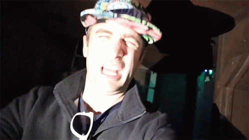 A Man Wearing A Hat And Sunglasses Making A Face GIF