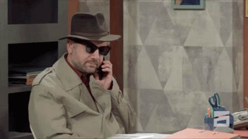 A Man Wearing A Hat And Sunglasses Talking On A Cell Phone GIF