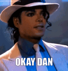 A Man Wearing A Hat And Tie Is Saying Okay Dan GIF
