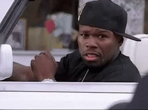 A Man Wearing A Hat Is Driving A Car And Making A Funny Face . GIF
