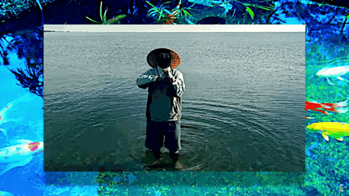 A Man Wearing A Hat Is Standing In A Body Of Water GIF
