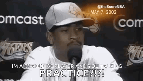 a man wearing a hat is talking into a microphone and says `` im a franchise player and you talking practice ? ''