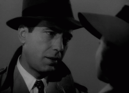 a man wearing a hat looks at a woman wearing a hat