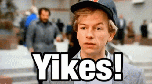 A Man Wearing A Hat Says " Yikes " In Front Of A Crowd GIF