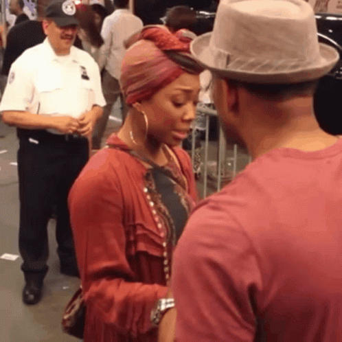 Man In Hat Talking To Woman With Turban GIF