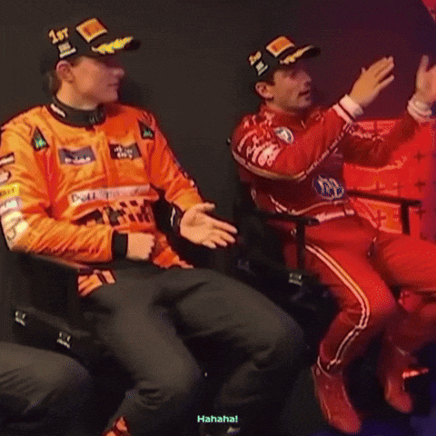 A Man Wearing A Hat That Says 1St Is Sitting Next To Another Man GIF
