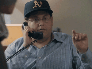A Man Wearing A Hat That Says A 'S Is Talking On A Phone GIF