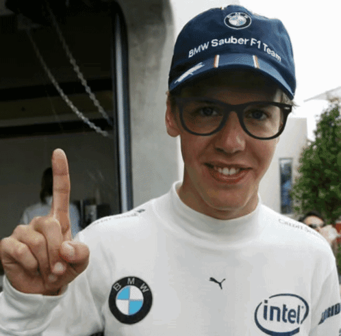 a man wearing a hat that says bmw sauber f1 team on it