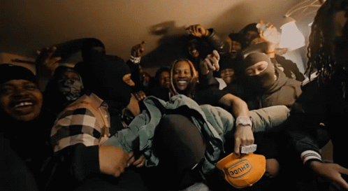 a man wearing a hat that says ' dank ' on it is surrounded by other men