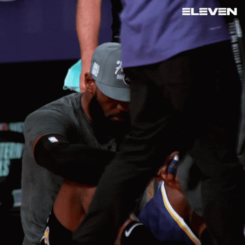 A Man Wearing A Hat That Says Finals Is Kneeling Down GIF