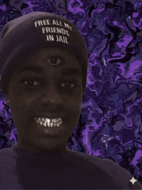 A Man Wearing A Hat That Says Free All My Friends In Jail Smiles GIF
