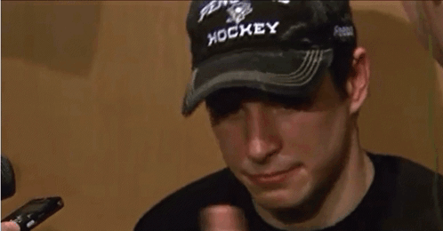 A Man Wearing A Hat That Says Hockey GIF