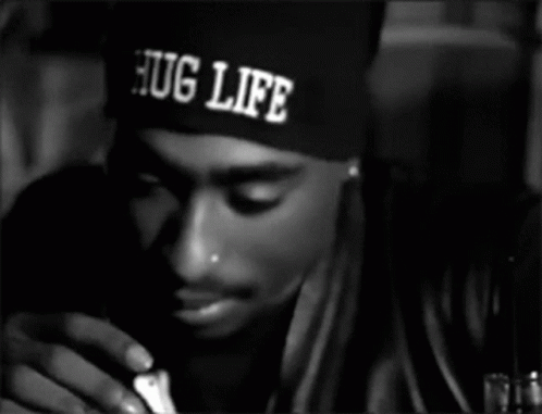 A Man Wearing A Hat That Says Hug Life On It GIF