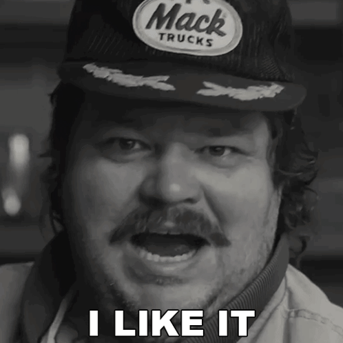 A Man Wearing A Hat That Says Mack Trucks Says I Like It GIF