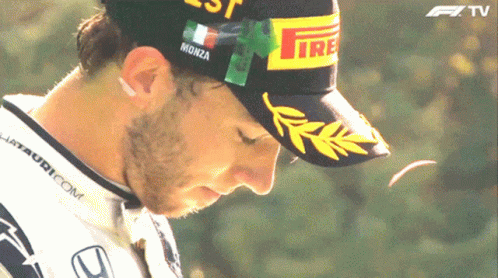 a man wearing a hat that says monza