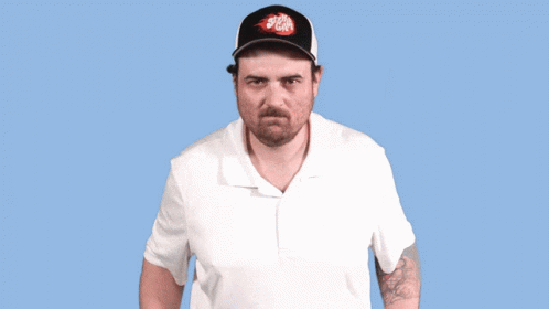 A Man Wearing A Hat That Says Stella Artois Makes A Funny Face GIF
