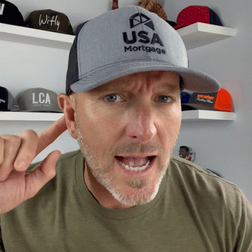 A Man Wearing A Hat That Says Usa Mortgage Is Making A Funny Face GIF