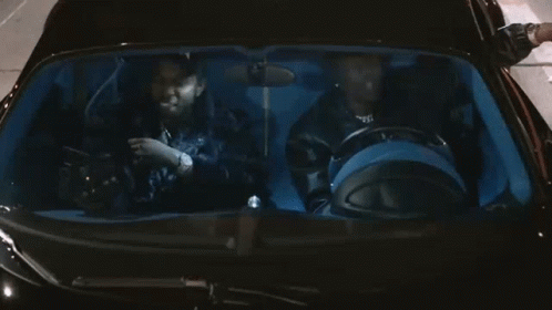 A Man Wearing A Hat That Says Xbok Is Sitting In A Car GIF