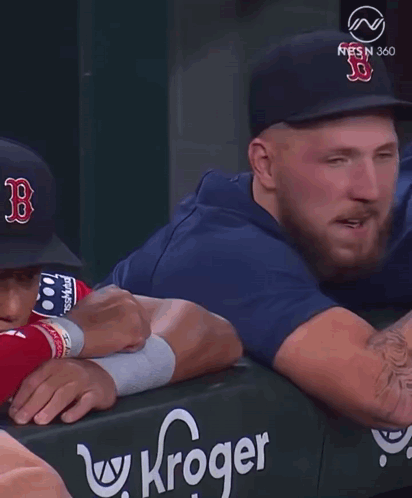 A Man Wearing A Hat With The Letter B On It Talks To Another Man GIF