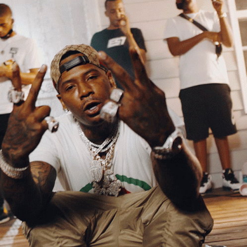 A Man Wearing A Hat With The Letter E7 On It Is Giving The Middle Finger GIF
