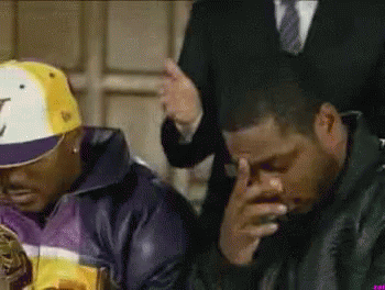 A Man Wearing A Hat With The Letter J On It Sits Next To Another Man GIF
