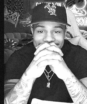 A Man Wearing A Hat With The Letter T On It GIF