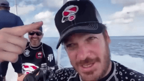 A Man Wearing A Hat With The Number 80 On It Is Pointing GIF