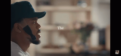 A Man Wearing A Hat With The Word " The " Above Him GIF