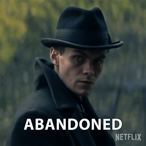 A Man Wearing A Hat With The Words Abandoned Written Below Him GIF