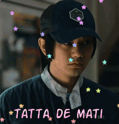 A Man Wearing A Hat With The Words Tatta De Mati On The Bottom GIF