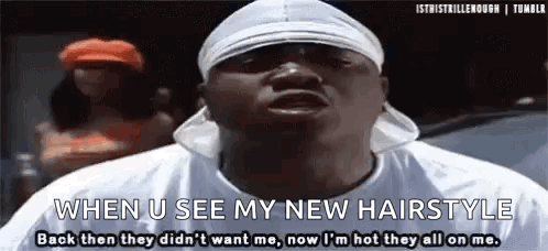 A Man Wearing A Headband And A White Shirt Is Talking About His New Hairstyle . GIF