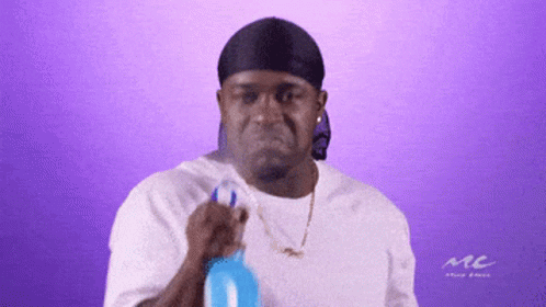 A Man Wearing A Headband And A White Shirt With The Word Mc On It GIF