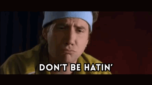 A Man Wearing A Headband And A Yellow Jacket Is Saying " Don 'T Be Hatin " GIF