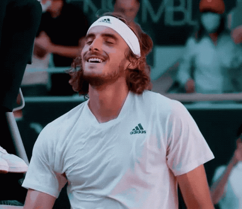 A Man Wearing A Headband And An Adidas Shirt Is Smiling GIF