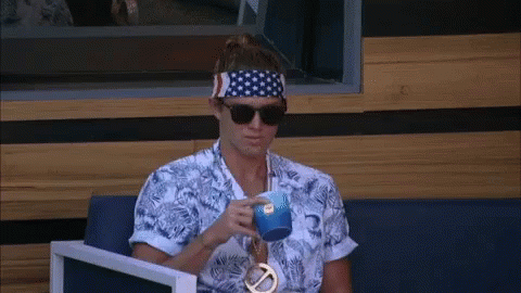 A Man Wearing A Headband And Sunglasses Is Drinking From A Cup GIF