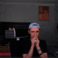 A Man Wearing A Headband Is Making A Funny Face With His Mouth Open GIF