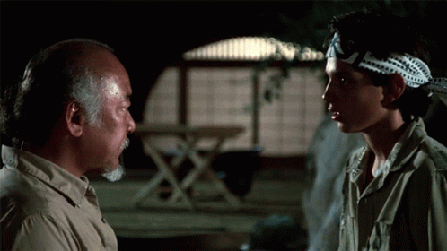 A Man Wearing A Headband That Says ' Karate Kid ' On It GIF