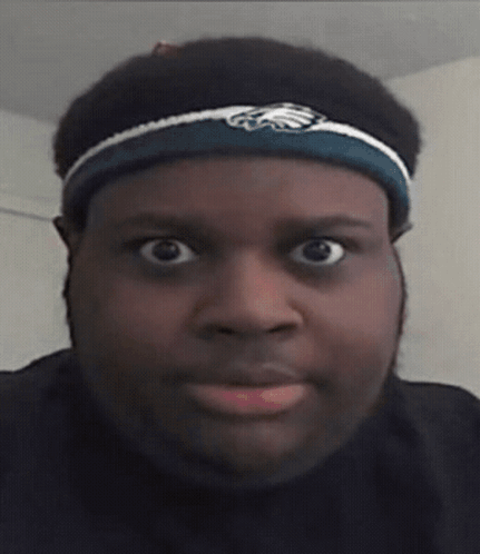A Man Wearing A Headband With An Eagle On It GIF
