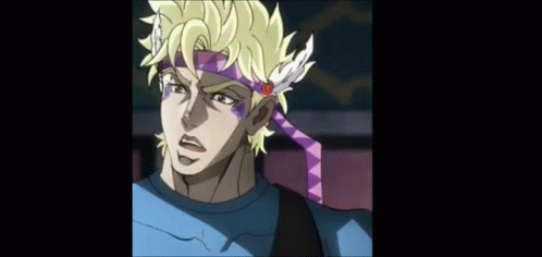 A Man Wearing A Headband With Feathers And A Flower On It GIF