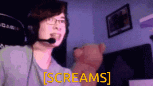 A Man Wearing A Headset And Holding A Teddy Bear Says Screams GIF