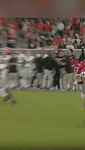 A Man Wearing A Headset Is Running On A Field GIF