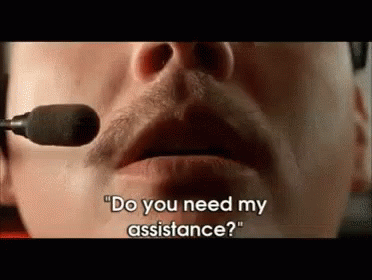 A Man Wearing A Headset Is Talking Into A Microphone And Asking If He Needs Assistance . GIF