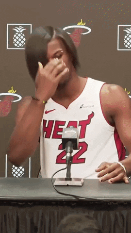 A Man Wearing A Heat 22 Jersey Is Sitting At A Table GIF