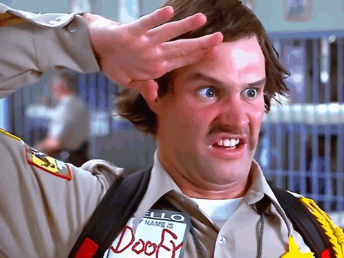 A Man Wearing A Hello My Name Is Doofy Tag GIF