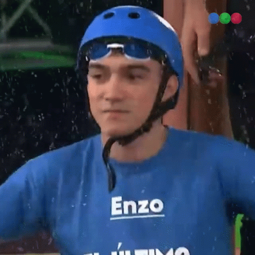 A Man Wearing A Helmet And A Blue Shirt With The Name Enzo On It GIF